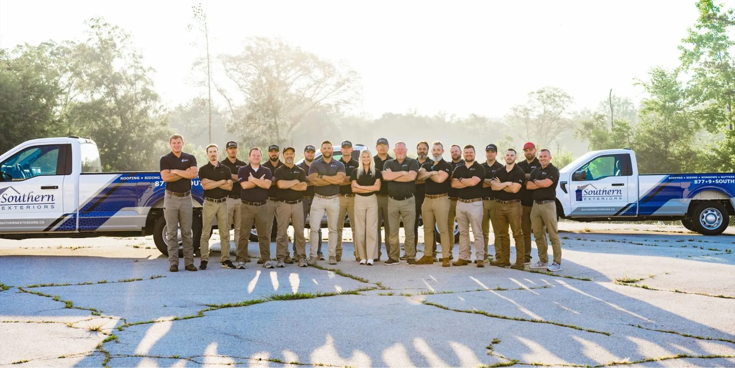 Southern Exteriors installation team standing together between company trucks
