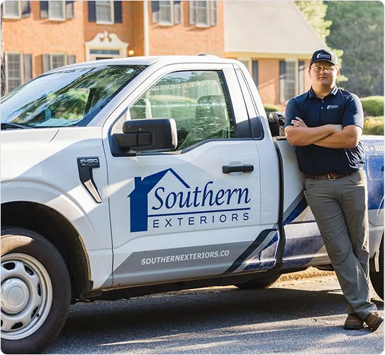 Southern Exteriors team member standing beside a branded company truck