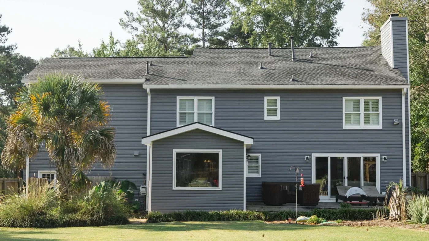 A North Atlanta home with newly installed gray siding with white trim.