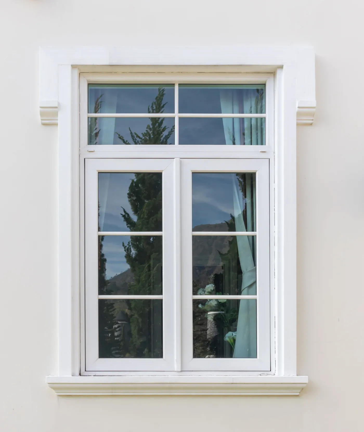 White windows with a white frame on a white house.
