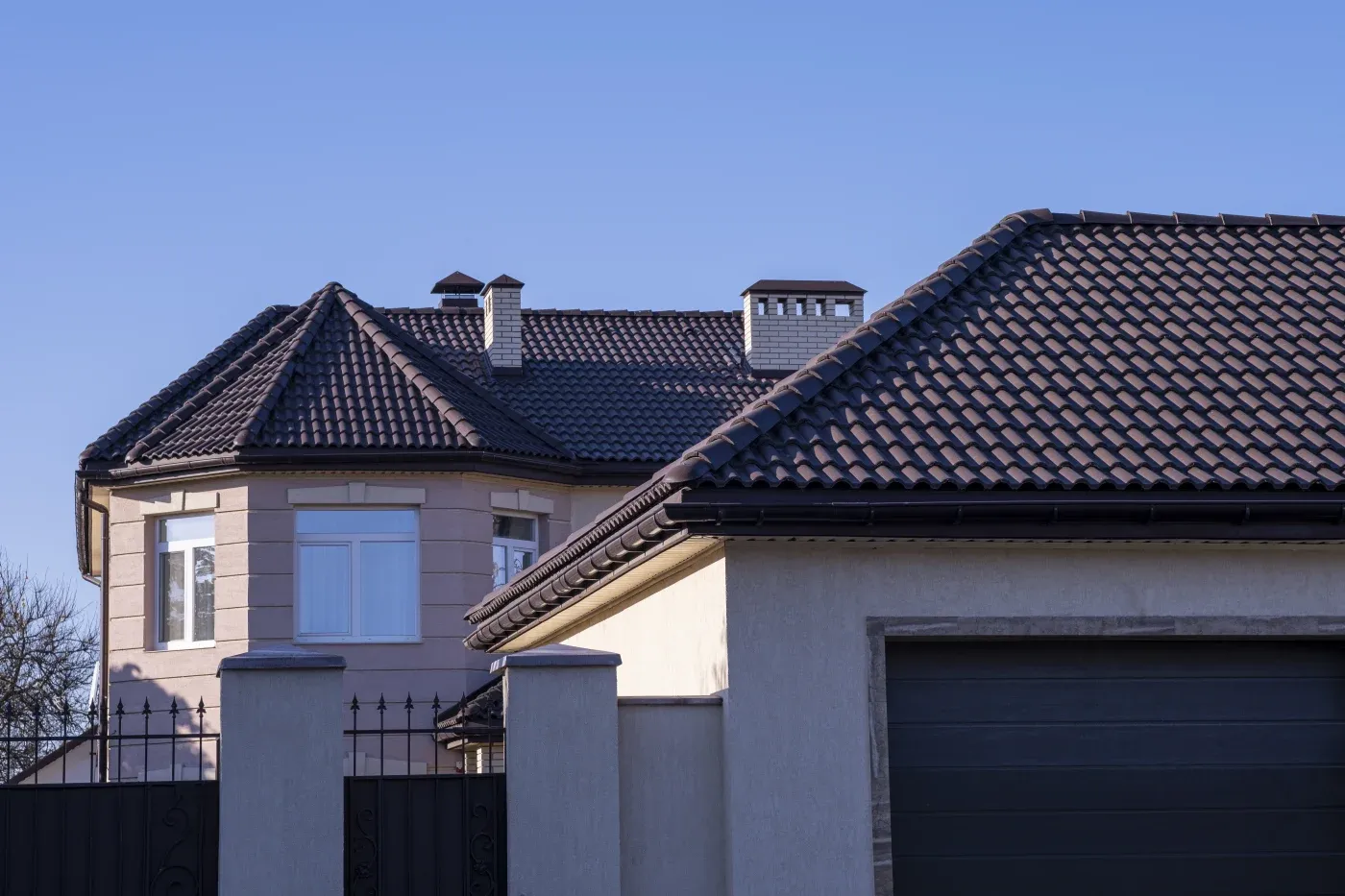 A brown metal roof on a gated home.