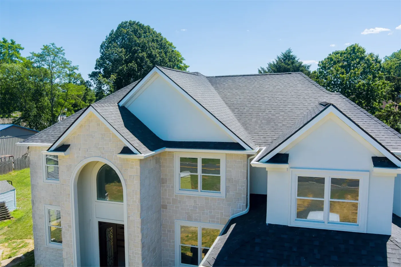 An asphalt shingle roof on a new two-story house.