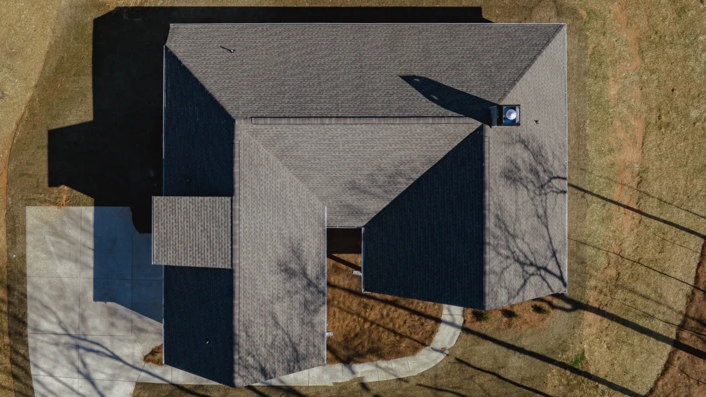 A brown asphalt shingle roof installed on a house.