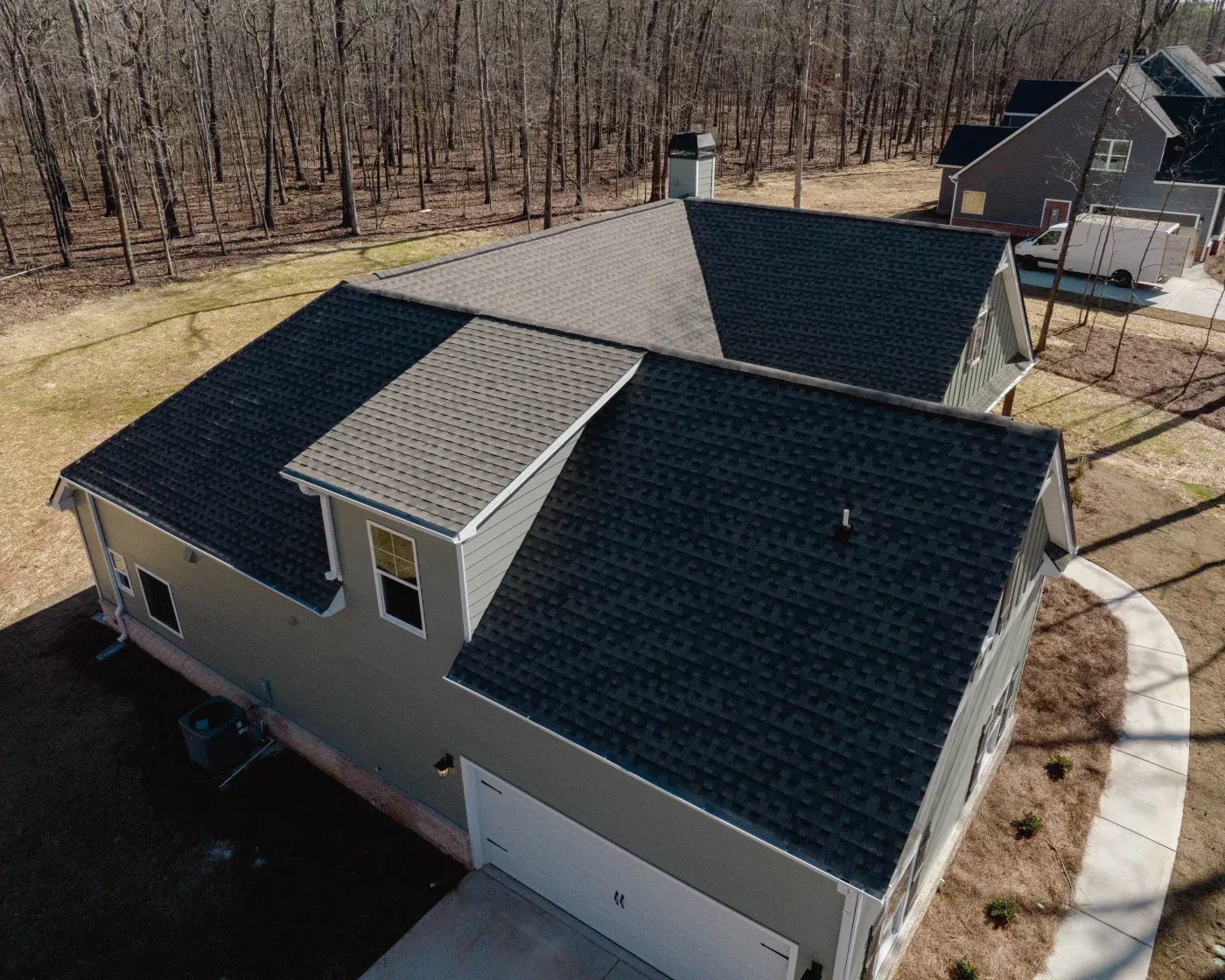 Black asphalt shingles installed on a North Atlanta home with gray siding.