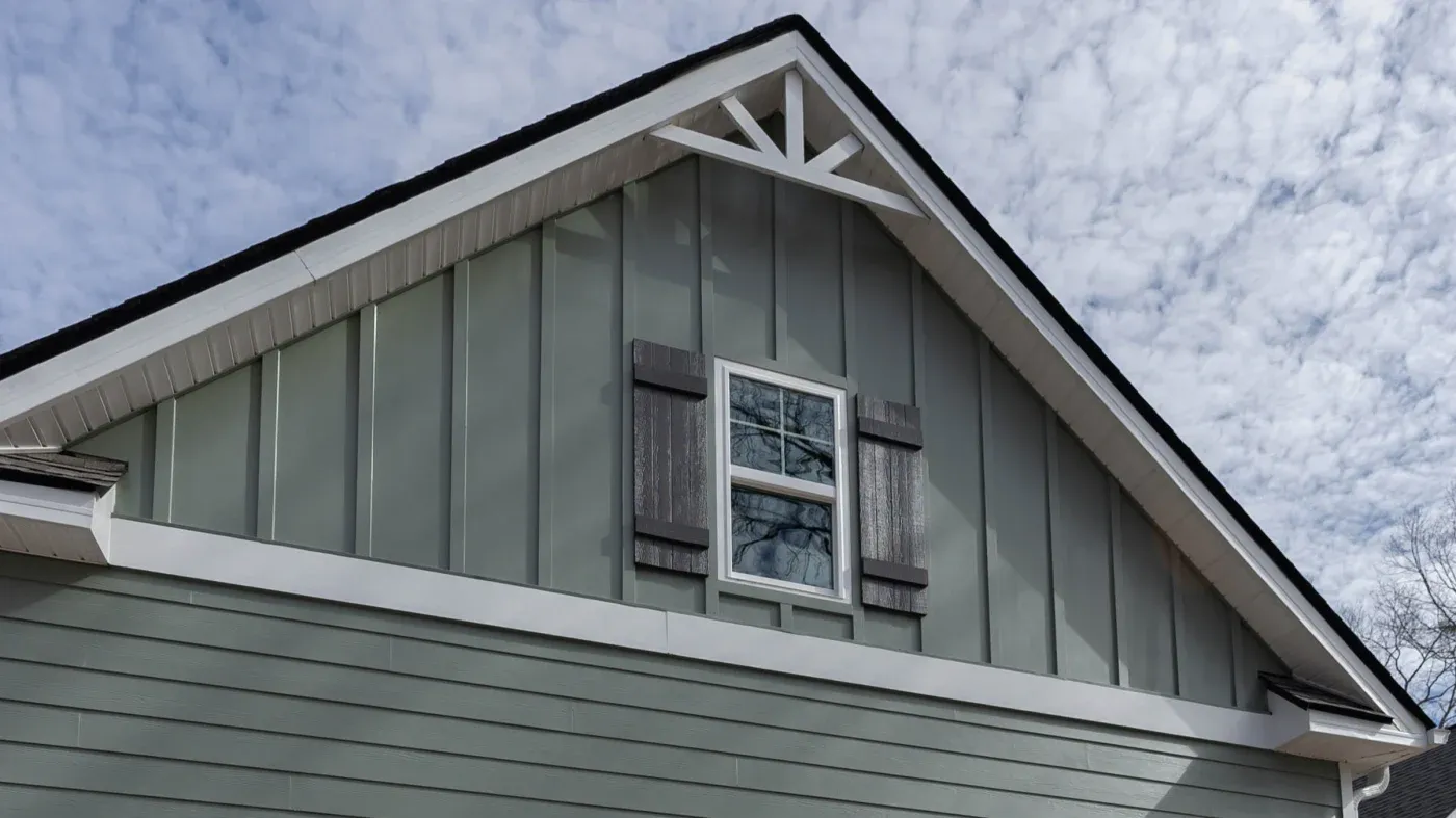 The upper story of a North Atlanta home with green James Hardie siding.