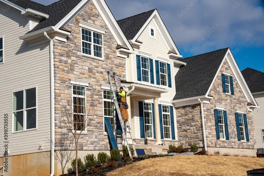 A crew of construction professionals working on an exterior project
