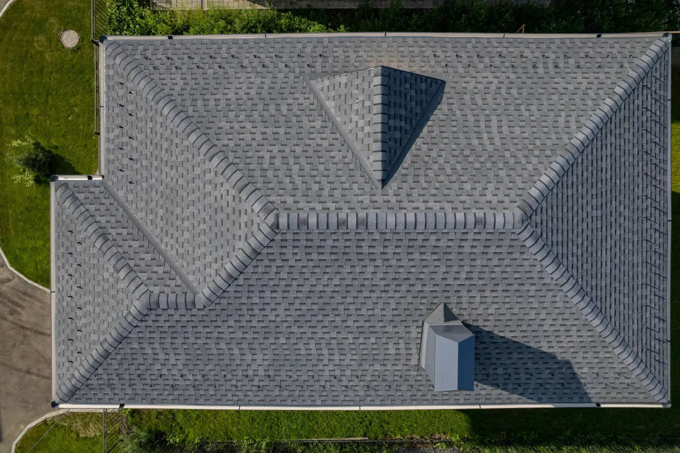 A close-up shot of new asphalt shingles layered perfectly.