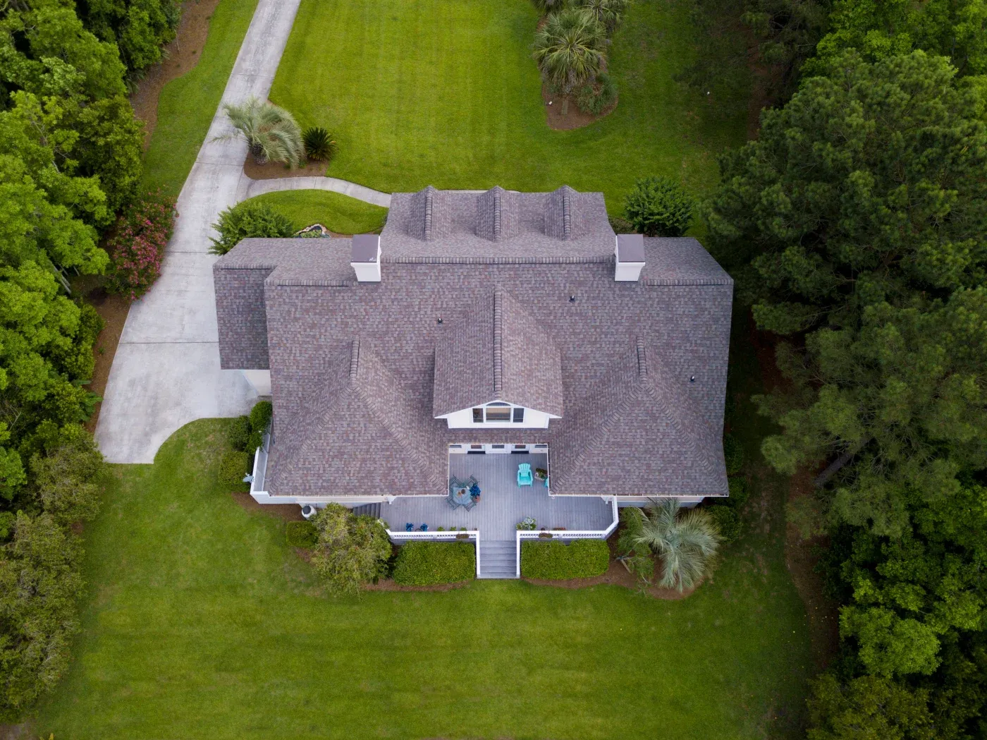 Aerial View Of Large Home With New Roof On Beautiful Property.