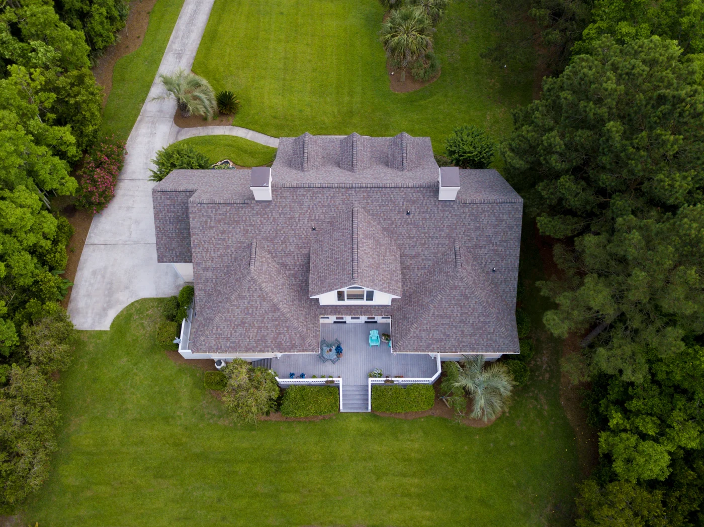 Aerial View Of Large Home With New Roof On Beautiful Property. Aerial View Of Large Home With New Roof On Beautiful Property.