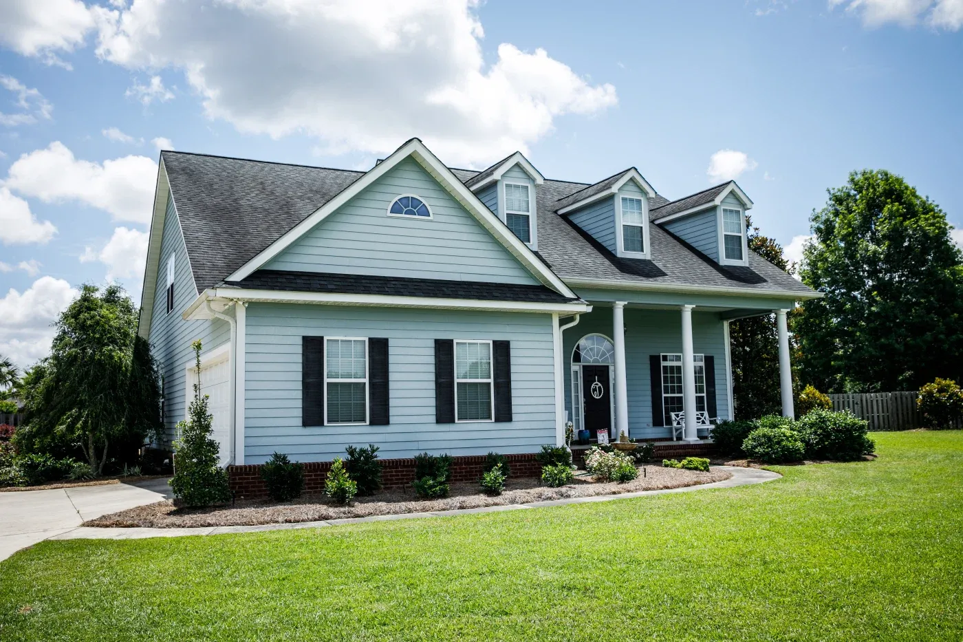 Blue Traditional Siding House Home In Suburbs Front Facing With Curb Appeal