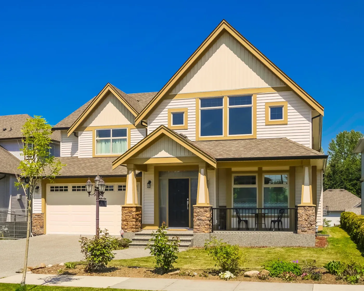 A two-story house with beige James Hardie siding in two styles – horizontal and vertical.