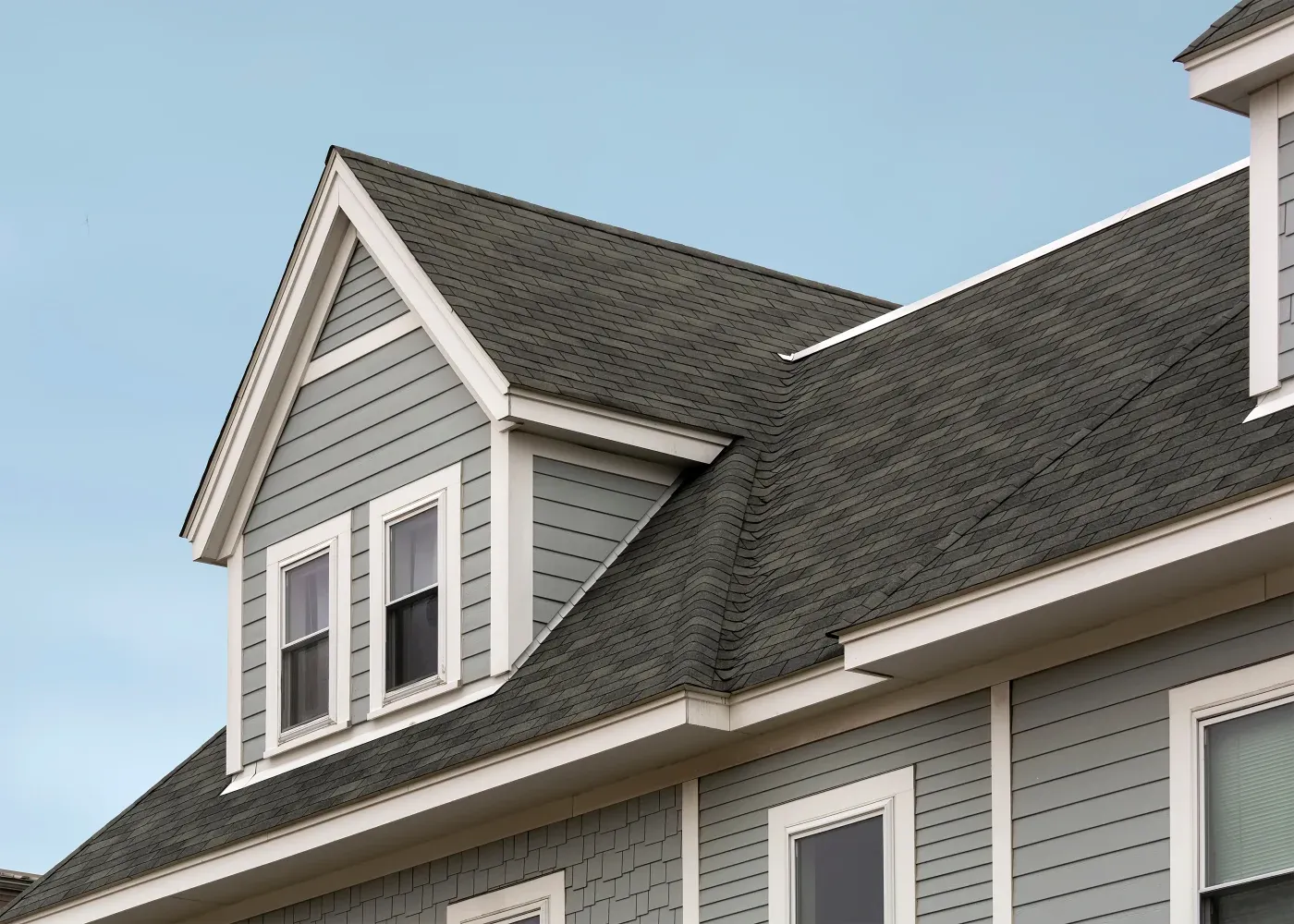 A close-up view of a professional steep-pitched asphalt shingle roof.