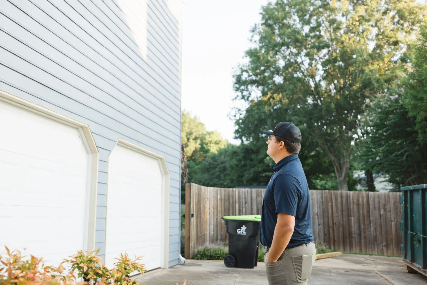 A Southern Exteriors employee looks at a home's siding