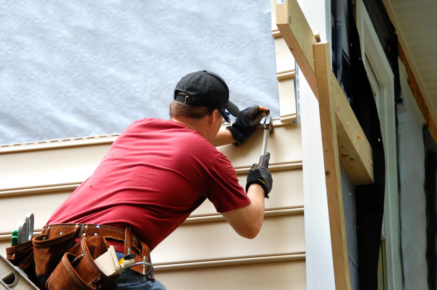A skilled contractor installing fiber cement siding on a home