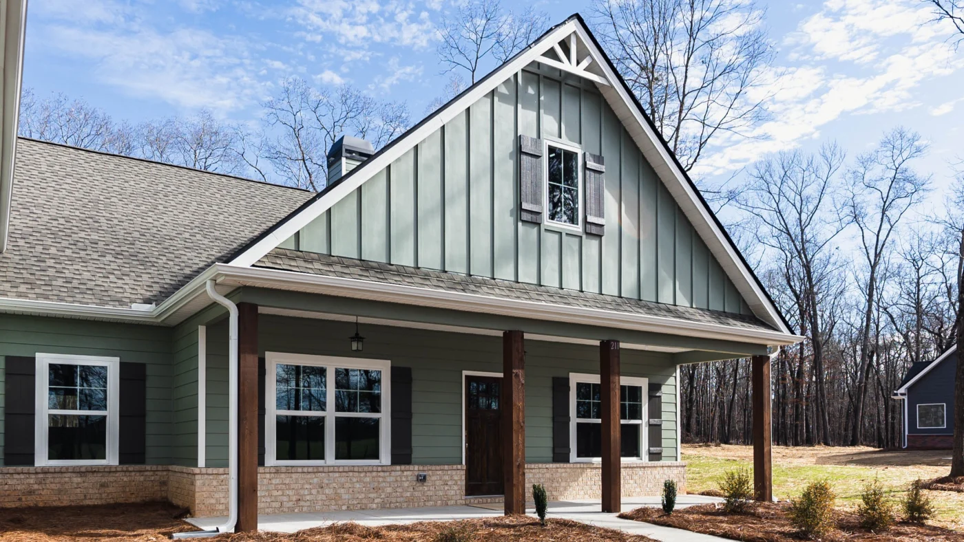 A completed home exterior showing contrasting siding styles and trim