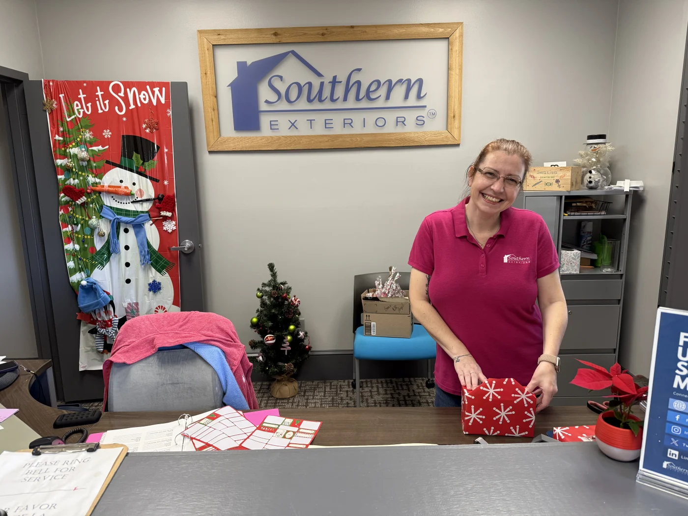 A Southern Exteriors team member wrapping Angel Tree gifts